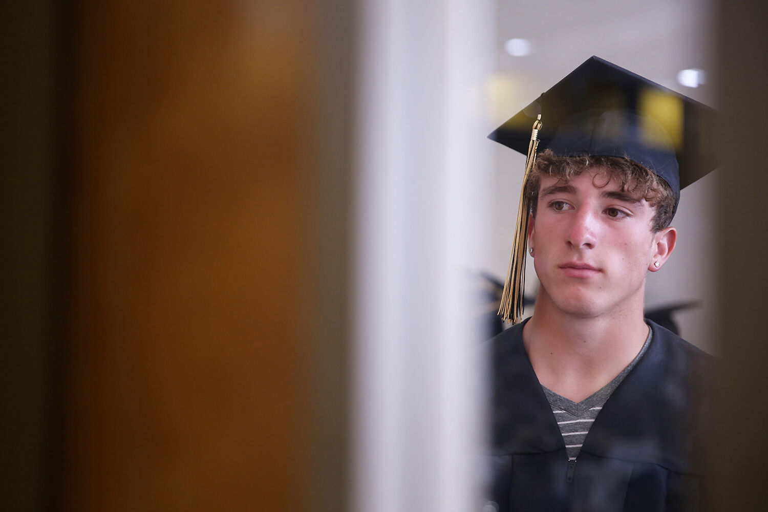 Alex Cahhal waits outside the gym for graduation